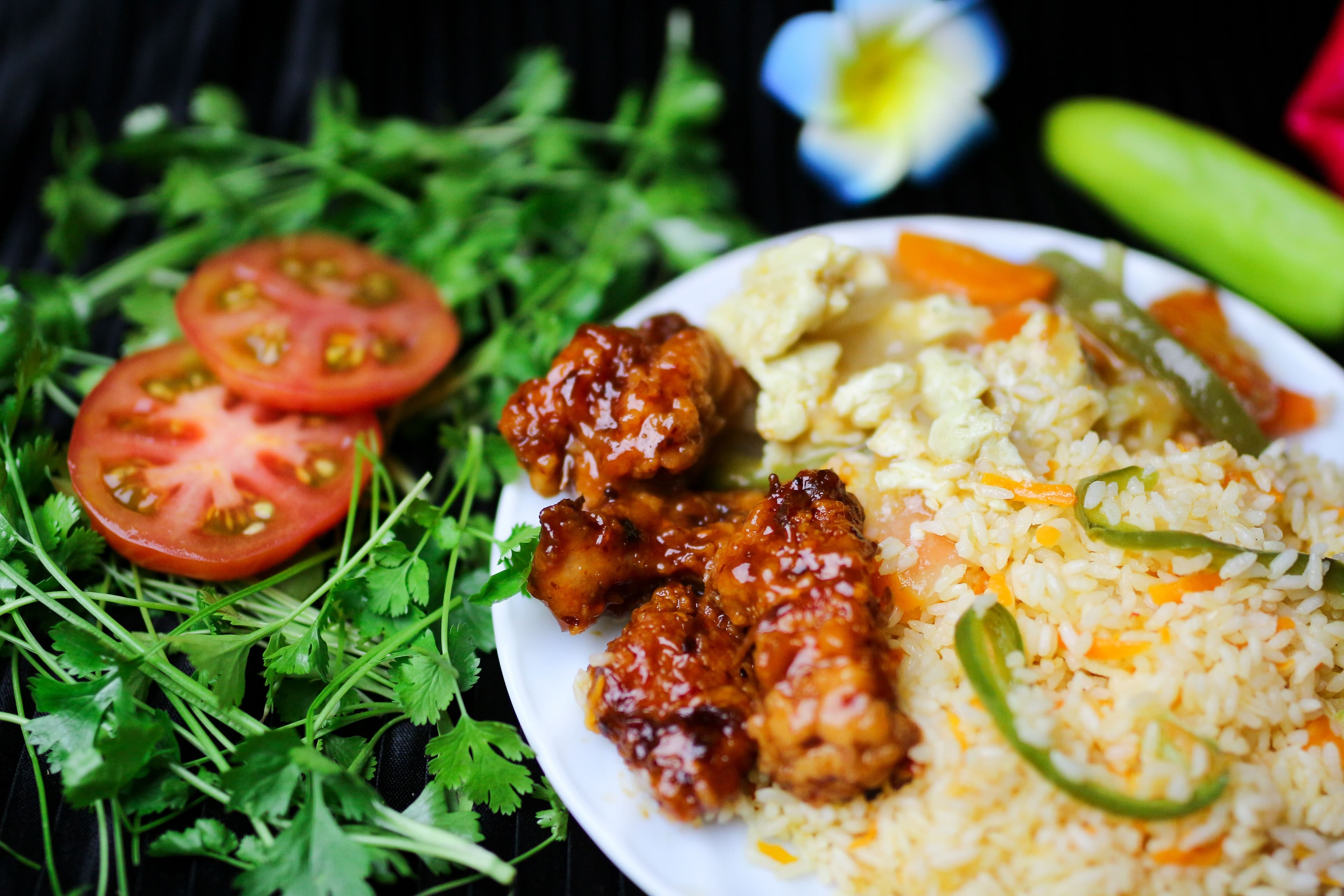 Asian-style meal with rice, chicken, and vegetables
